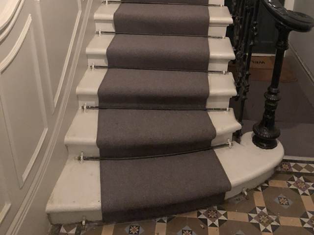 Grey Carpet With Rods Installed In Pimlico